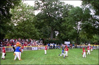 A little league Cardinal flies to second base during the first game of the 2004 White House Tee Ball season June 13, 2004. The Bolling Air Force Base Little League Cardinals and the Cherry Point Marine Corps Air Station Devil Dogs met on the field for a decisive battle, in which both teams earned signed baseballs from the President and hotdogs. 