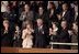 Mrs. Bush applauds her special guest, Dr. Adnan Pachachi, President of the Iraqi Governing Council, during President Bush's State of the Union Address at the U.S. Capitol Tuesday, Jan. 20, 2004. "Sir, America stands with you and the Iraqi people as you build a free and peaceful nation," said the President in his acknowledgement of Dr. Pachachi.