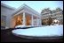 The West Wing entrance glows as the sun rises on a snowy day at the White House, Friday, Dec. 6, 2002. 