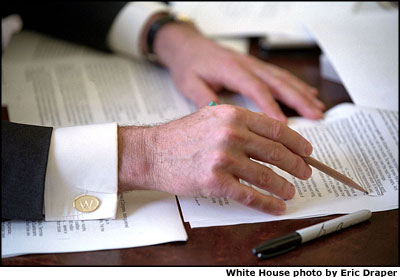 Sitting at his desk in the Oval Office, President Bush reviews the State of the Union address line-by-line and word-by-word. White House photo by Eric Draper.