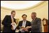 Advisors Dan Bartlett, left, and Mike Gerson work with President George W. Bush Tuesday, Feb. 1, 2005, in the Oval Office fine-tuning his State of the Union address scheduled to be delivered Wednesday night. 