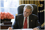 President George W. Bush reads over a draft of his State of the Union speech in the Oval Office Tuesday morning, Jan. 31, 2006, in preparation for the annual address to the nation that evening.