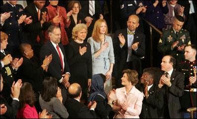 Mrs. Laura Bush applauds the family of Staff Sgt. Dan Clay Tuesday night as they were acknowledged by President George W. Bush during his State of the Union address. Family members of Sgt. Clay, who was killed in Iraq, are his father, Clarence; mother, Sara Jo, and wife, Lisa.