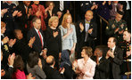 Mrs. Laura Bush applauds the family of Staff Sgt. Dan Clay Tuesday night as they were acknowledged by President George W. Bush during his State of the Union address. Family members of Sgt. Clay, who was killed in Iraq, are his father, Clarence; mother, Sara Jo, and wife, Lisa.