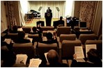 Advisers listen to President Bush’s delivery of his speech in the family theater of the White House Jan. 24, 2003. 