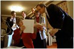 Advisor Karen Hughes reviews parts of the speech with White House Staff Secretary Harriet Miers and Director of Communications Dan Bartlett as White House speechwriters confer behind them during a rehearsal in the family theater of the White House Jan. 26, 2003.