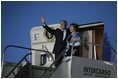 President George W. Bush and Laura Bush wave from Air Force One after landing Thursday, Nov. 3, 2005, in Mar del Plata, Argentina, where the President will participate in the Summit of the Americas.