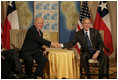 President George W. Bush and Chilean President Ricardo Lago Escobar exchange handshakes Friday, Nov. 4, 2005, during their bilateral meeting at the Sheraton Mar del Plata Hotel in Mar del Plata, Argentina.