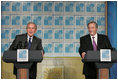 President George W. Bush and Argentina's President Nestor Carlos Kirchner smile as they hold a joint press availability Friday, Nov. 4, 2005, after meeting privately at the Hermitage Hotel in Mar del Plata, Argentina.