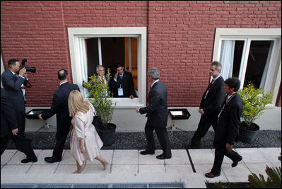 President George W. Bush acknowledges a salute from a well-wisher Friday, Nov. 4, 2005, during the opening ceremonies in Mar del Plata, Argentina, for the 2005 Summit of the Americas.