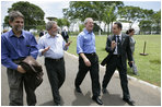 President George W. Bush enjoys a walk with Brazilian President Luiz Inacio Lula da Sliva following their joint statement at the Granja do Torto in Brasila, Brazil, Sunday, Nov. 6, 2005. 