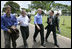 President George W. Bush enjoys a walk with Brazilian President Luiz Inacio Lula da Sliva following their joint statement at the Granja do Torto in Brasila, Brazil, Sunday, Nov. 6, 2005. 