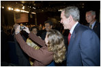 President George W. Bush poses for a photo with an audience member after delivering remarks in Brasilia, Brazil, Sunday, Nov. 6, 2005. 