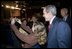 President George W. Bush poses for a photo with an audience member after delivering remarks in Brasilia, Brazil, Sunday, Nov. 6, 2005. 