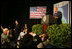 The media swarms President George W. Bush Saturday, Nov. 6, 2005, as he speaks at Blue Tree Stars Hall in Brasilia, Brazil, prior to his departure for Panama. 