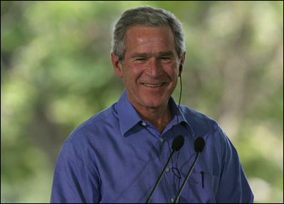 President George W. Bush smiles as he listens through an earpiece to a translation of the remarks by Brazil President Luiz Inacio Lula da Silva Saturday, Nov. 6, 2005, in Brasilia, Brazil. 