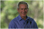 President George W. Bush smiles as he listens through an earpiece to a translation of the remarks by Brazil President Luiz Inacio Lula da Silva Saturday, Nov. 6, 2005, in Brasilia, Brazil. 