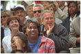 The President and Mrs. Bush watch the action during a tee-ball game on the South Lawn May 6, 2001.