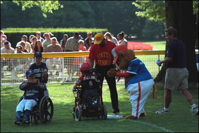 With coaches and a big furry mascot on hand, the bases were always loaded with activity during the third Tee Ball game on the South Lawn on Sunday, July 15, 2001.