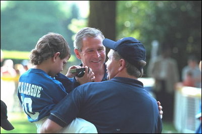 Greeting the players and coaches, President Bush makes new friends while hosting the third tee-ball game at his home during the third Tee Ball game on the South Lawn on Sunday, July 15, 2001.