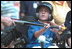 Decked out in T-shirts proclaiming themselves as either ""South Lawn Sluggers"" or ""South Lawn Buddies,"" about two dozen little leaguers played tee-ball on the White House South Lawn Sunday July 15, 2001.