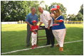 President George W. Bush attends a Tee Ball on the South Lawn with Cal Ripken, game between the Cardinals and the South Berkeley Little League Braves from Inwood, West Virginia. June 23, 2002.