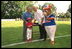 President George W. Bush attends a Tee Ball on the South Lawn with Cal Ripken, game between the Cardinals and the South Berkeley Little League Braves from Inwood, West Virginia. June 23, 2002.