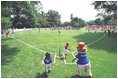 President George W. Bush attends a Tee Ball on the South Lawn game between the Cardinals and the South Berkeley Little League Braves from Inwood, West Virginia. June 23, 2002.