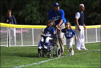 President George W. Bush hosts a White House Tee Ball (t-ball) game on the South Lawn between the Waynesboro, Virginia Little League Challenger Division Sand Gnats (Blue Team) vs. the East Brunswick, New Jersey Babe Ruth Buddy Ball League Sluggers (Red Team) September 22, 2002.