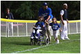 President George W. Bush hosts a White House Tee Ball (t-ball) game on the South Lawn between the Waynesboro, Virginia Little League Challenger Division Sand Gnats (Blue Team) vs. the East Brunswick, New Jersey Babe Ruth Buddy Ball League Sluggers (Red Team) September 22, 2002.