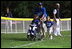 President George W. Bush hosts a White House Tee Ball (t-ball) game on the South Lawn between the Waynesboro, Virginia Little League Challenger Division Sand Gnats (Blue Team) vs. the East Brunswick, New Jersey Babe Ruth Buddy Ball League Sluggers (Red Team) September 22, 2002.