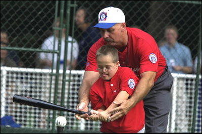 President George W. Bush hosts a White House Tee Ball (t-ball) game on the South Lawn between the Waynesboro, Virginia Little League Challenger Division Sand Gnats (Blue Team) vs. the East Brunswick, New Jersey Babe Ruth Buddy Ball League Sluggers (Red Team) September 22, 2002.