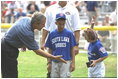 President George W. Bush hosts a White House Tee Ball (t-ball) game on the South Lawn between the Waynesboro, Virginia Little League Challenger Division Sand Gnats (Blue Team) vs. the East Brunswick, New Jersey Babe Ruth Buddy Ball League Sluggers (Red Team) September 22, 2002.