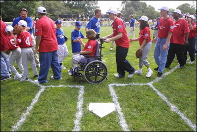 President George W. Bush hosts a White House Tee Ball (t-ball) game on the South Lawn between the Waynesboro, Virginia Little League Challenger Division Sand Gnats (Blue Team) vs. the East Brunswick, New Jersey Babe Ruth Buddy Ball League Sluggers (Red Team) September 22, 2002.