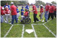 President George W. Bush hosts a White House Tee Ball (t-ball) game on the South Lawn between the Waynesboro, Virginia Little League Challenger Division Sand Gnats (Blue Team) vs. the East Brunswick, New Jersey Babe Ruth Buddy Ball League Sluggers (Red Team) September 22, 2002.