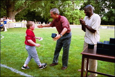 President George W. Bush hosts Tee Ball on the South Lawn with The Oriole Advocates Challengers of Marley Area Little League of Glen Burnie, Maryland and The Ridley Police Challengers of Leedom Little League, Ridley Park, Pennsylvania, July 27, 2003.