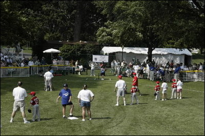 President George W. Bush hosts Tee Ball on the South Lawn with The Oriole Advocates Challengers of Marley Area Little League of Glen Burnie, Maryland and The Ridley Police Challengers of Leedom Little League, Ridley Park, Pennsylvania, July 27, 2003.