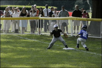 The first basemen from the Hamilton Little Lads Cal Ripken League of Hamilton, N.J., makes a play during a fast-paced game against the Milwood Little League of Kalamazoo, Mich., during the last game of the 2003 White House South Lawn Tee Ball season Sunday, Sept. 7, 2003.