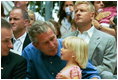 During the game, President Bush spends a few moments with a little league fan during the first game of the 2004 White House Tee Ball season June 13, 2004.