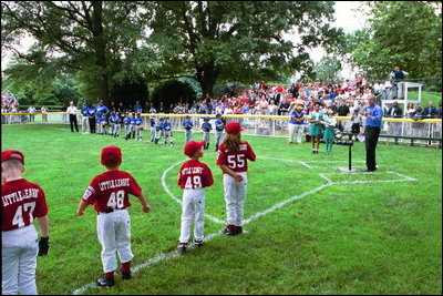 Kicking off the fourth season of White House Tee Ball, President Bush speaks during the first game of the 2004 season June 13, 2004. President Bush started the league to encourage foster a spirit of teamwork and service in America's youth.