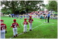 Kicking off the fourth season of White House Tee Ball, President Bush speaks during the first game of the 2004 season June 13, 2004. President Bush started the league to encourage foster a spirit of teamwork and service in America's youth.