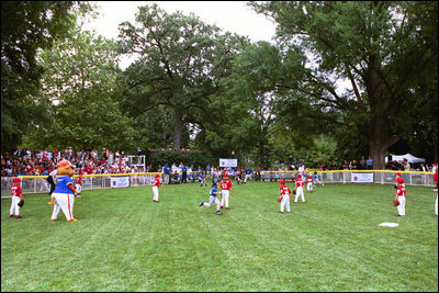 A little league Cardinal flies to second base during the first game of the 2004 White House Tee Ball season June 13, 2004. The Bolling Air Force Base Little League Cardinals and the Cherry Point Marine Corps Air Station Devil Dogs met on the field for a decisive battle, in which both teams earned signed baseballs from the President and hotdogs.