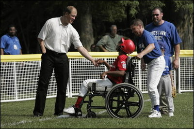 Former Major League pitcher Jim Abbott congratulates a player from the Challenger Phillies from Middletown, Delaware at Tee Ball on the South Lawn at the White House on Sunday July 11, 2004.