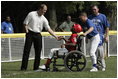 Former Major League pitcher Jim Abbott congratulates a player from the Challenger Phillies from Middletown, Delaware at Tee Ball on the South Lawn at the White House on Sunday July 11, 2004.