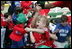 A young ballplayer from the West University Little League Challengers from Houston, Texas,  cheers with her team Sunday, July 24, 2005, at a Tee Ball game on the South Lawn of the White House.