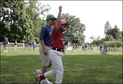 A player from the West University Little League Challengers from Houston, Texas cheers after scoring a run during a game on the South Lawn of the White House on Sunday July 24, 2005.