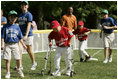 A player from the West University Little League Challengers from Houston, Texas, heads for homeplate to score a run, Sunday, July 24, 2005, during a Tee Ball game on the South Lawn of the White House.