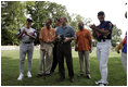 President George W. Bush laughs with Major League Baseball Hall of Fame players Ozzie Smith and Paul Molitor and former umpire Steve Palermo while congratulating Challenger Tee Ball players after a game on the South Lawn of the White House on Sunday July 24, 2005.