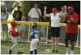 Secretary of Education Margaret Spellings is on her toes as she declares safe at first Naji Loggins of the Newark (New Jersey) Black Yankees after Naji singled during "Tee Ball on the South Lawn."