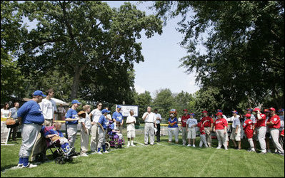 President George W. Bush welcomes players and guests to the White House Sunday, July 30, 2006, for the Tee Ball on the South Lawn game between the Thurmont Little League Civitan Club of Frederick Challengers of Thurmont, Md., and the Shady Spring Little League Challenger Braves of Shady Spring, W. Va.